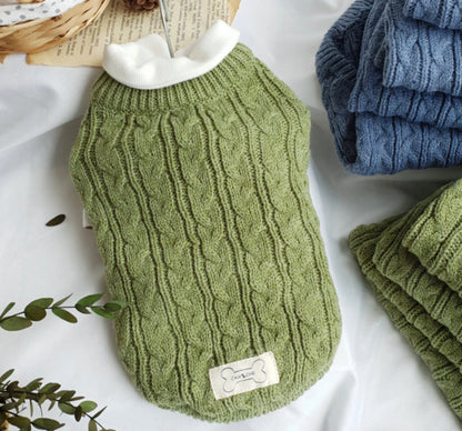 Olive cable-knit sweater layered over a separate white shirt